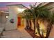 A welcoming arched entryway is enhanced by desert landscaping, including mature palm trees at 22416 N Arrellaga Dr, Sun City West, AZ 85375