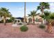 Backyard patio surrounded by palm trees and desert landscaping at 22416 N Arrellaga Dr, Sun City West, AZ 85375