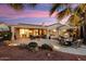 Scenic backyard featuring multiple seating areas, mature palms, desert landscaping, and large windows at 22416 N Arrellaga Dr, Sun City West, AZ 85375
