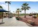 Landscaped backyard featuring a patio, outdoor seating, and views of the community golf course at 22416 N Arrellaga Dr, Sun City West, AZ 85375
