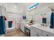 Well-lit bathroom with double sinks, a shower with a curtain, and neutral décor at 22416 N Arrellaga Dr, Sun City West, AZ 85375