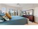 Bright bedroom with a large bed, dresser, and windows with shutter offering plenty of natural light at 22416 N Arrellaga Dr, Sun City West, AZ 85375