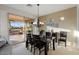 Elegant dining room features dark wood table set and a sliding glass door to the outside patio at 22416 N Arrellaga Dr, Sun City West, AZ 85375