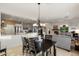 Dining area with stylish chandelier, seamlessly connected to the modern kitchen and living room at 22416 N Arrellaga Dr, Sun City West, AZ 85375