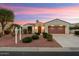 Charming home featuring a desert landscaped yard, arched entryway, and a two-car garage at 22416 N Arrellaga Dr, Sun City West, AZ 85375