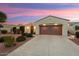 Well-maintained home boasting desert landscaping, an arched entryway, and a two-car garage at 22416 N Arrellaga Dr, Sun City West, AZ 85375