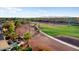 Back view of home showcasing a meticulously maintained golf course, palm trees, and desert landscaping in a beautiful setting at 22416 N Arrellaga Dr, Sun City West, AZ 85375