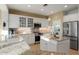 Well-lit kitchen featuring granite countertops, stainless steel appliances, and ample cabinet space at 22416 N Arrellaga Dr, Sun City West, AZ 85375