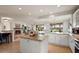 Spacious open concept kitchen with granite countertops, stainless appliances, and great natural light at 22416 N Arrellaga Dr, Sun City West, AZ 85375