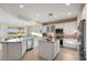 Modern kitchen with granite counters, stainless steel appliances, central island, and an open layout at 22416 N Arrellaga Dr, Sun City West, AZ 85375