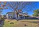 Large backyard with grass, patio, mature trees, and a two-story home with a balcony at 2325 S 88Th Dr, Tolleson, AZ 85353