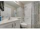 Bright bathroom featuring white cabinets, vanity, a large mirror and a shower and bathtub combination at 2325 S 88Th Dr, Tolleson, AZ 85353