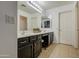 Bright bathroom featuring double sinks, a vanity area, and neutral tile flooring at 2325 S 88Th Dr, Tolleson, AZ 85353