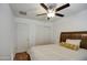 Comfortable bedroom with wood floors, a ceiling fan, and a bed with decorative pillows at 2325 S 88Th Dr, Tolleson, AZ 85353