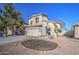 Lovely two-story home featuring a spacious concrete driveway, desert landscape, and a two-car garage at 2325 S 88Th Dr, Tolleson, AZ 85353