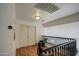 Hallway featuring wood floors, white doors, wood railing and a view of the downstairs at 2325 S 88Th Dr, Tolleson, AZ 85353