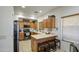 Cozy kitchen featuring wooden cabinets, stainless steel appliances, breakfast bar with seating, and lots of counter space at 2325 S 88Th Dr, Tolleson, AZ 85353