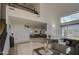 Spacious living room boasts soaring ceilings, large windows, an upstairs loft, and a view into the kitchen area at 2325 S 88Th Dr, Tolleson, AZ 85353