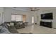 Comfortable living room offering tile flooring, ample seating, natural light, and an entertainment center at 2325 S 88Th Dr, Tolleson, AZ 85353