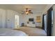 Main bedroom features a ceiling fan, large windows, a sliding glass door to the patio, and a walk-in closet at 2325 S 88Th Dr, Tolleson, AZ 85353