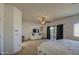 Spacious main bedroom with a ceiling fan, dresser, and balcony access, perfect for relaxation at 2325 S 88Th Dr, Tolleson, AZ 85353
