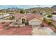 An aerial view of a charming single-story home with a tile roof and desert landscaping, complemented by mountain views at 2365 E Shea Blvd, Phoenix, AZ 85028