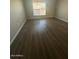 Bedroom with wood floors, light walls, and a bright window at 2625 E Indian School Rd # 335, Phoenix, AZ 85016