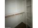 Walk-in closet with shelves and a wooden closet rod at 2625 E Indian School Rd # 335, Phoenix, AZ 85016