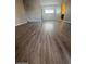 Well-lit living room with wood flooring extending throughout the space at 2625 E Indian School Rd # 335, Phoenix, AZ 85016