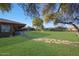 Enjoy the sprawling green backyard with mature trees, offering plenty of space for outdoor activities and relaxation at 2718 E Campo Bello Dr, Phoenix, AZ 85032