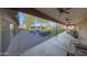 Covered backyard patio features an outdoor kitchen, ceiling fans, and comfortable seating, perfect for entertaining at 2718 E Campo Bello Dr, Phoenix, AZ 85032