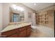 Well-lit bathroom features a single sink vanity, shower-tub combo, and travertine tile surround at 2718 E Campo Bello Dr, Phoenix, AZ 85032