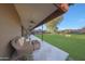 Relax on the covered patio with comfortable seating and ceiling fans, overlooking the large backyard at 2718 E Campo Bello Dr, Phoenix, AZ 85032