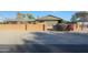 Mid-century home with red brick fence and desert landscaping at 2718 E Campo Bello Dr, Phoenix, AZ 85032