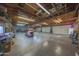 Large garage space with high ceilings, ample storage, and multiple garage doors at 2718 E Campo Bello Dr, Phoenix, AZ 85032