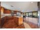 Open-concept kitchen with granite countertops, stainless steel appliances, and a spacious island with breakfast bar seating at 2718 E Campo Bello Dr, Phoenix, AZ 85032