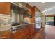 Bright kitchen features stainless steel appliances, granite counters, mosaic tile backsplash, and island with bar seating at 2718 E Campo Bello Dr, Phoenix, AZ 85032