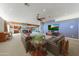 Inviting living room featuring comfortable leather sofas, ceiling fan, and views into the adjacent kitchen and living areas at 2718 E Campo Bello Dr, Phoenix, AZ 85032
