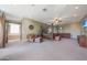 Spacious primary bedroom with a king bed, ceiling fan, and sitting area perfect for relaxation in a private setting at 2718 E Campo Bello Dr, Phoenix, AZ 85032
