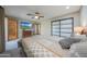 Comfortable bedroom featuring a ceiling fan, and access to the ensuite bathroom at 2718 E Campo Bello Dr, Phoenix, AZ 85032