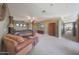 Spacious main bedroom featuring a seating area, ceiling fan, and access to the main bathroom at 2718 E Campo Bello Dr, Phoenix, AZ 85032