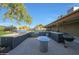 Entertain your guest in this outdoor kitchen that includes built-in grill and bar with a clear blue sky backdrop at 2718 E Campo Bello Dr, Phoenix, AZ 85032