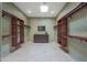 Spacious walk-in closet featuring custom shelving, natural light, and a central dresser at 2718 E Campo Bello Dr, Phoenix, AZ 85032