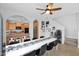 Dining area featuring a large white table, sleek black chairs, and views into the kitchen at 2955 N Brighton --, Mesa, AZ 85207