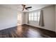 Bedroom features wood-look floors, ceiling fan, and natural light coming through plantation shutters at 3548 E Tina Dr, Phoenix, AZ 85050