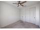 Neutral bedroom with carpet and a ceiling fan, featuring white closet doors for ample storage at 3548 E Tina Dr, Phoenix, AZ 85050