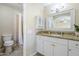 Bathroom showcases vanity with granite countertop, framed mirror, and a shower with neutral tiling at 3632 W Kelton Ln, Phoenix, AZ 85053