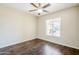 Bedroom featuring hardwood flooring, a ceiling fan, and a window for natural light at 3632 W Kelton Ln, Phoenix, AZ 85053