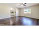 Spacious bedroom boasts hardwood floors, a ceiling fan, and an archway to the ensuite bathroom at 3632 W Kelton Ln, Phoenix, AZ 85053