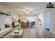 Virtually staged open-concept dining area with neutral tile flooring, and adjacent living room views at 3632 W Kelton Ln, Phoenix, AZ 85053